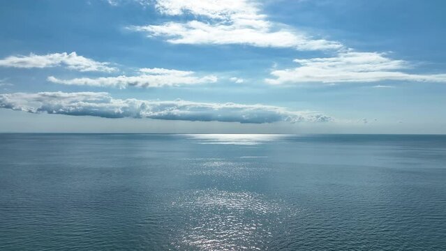 MONFALCONE, ITALY - APRIL, 2023: Sailing yacht moored off the coast Adriatic sea in Italy at sunny day. Drone aerial view, cinematic frame. Romantic atmosphere. Calm and pacifying scene.