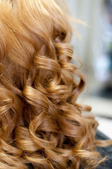 Beautiful light, wavy curls, hairstyle closeup