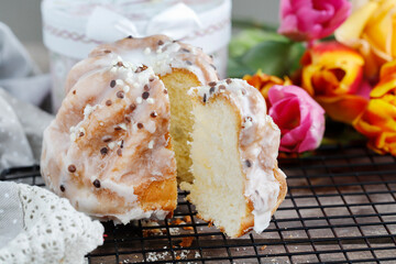 Traditional easter cake and bouquet of tulips in the background.