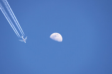 A Jet Flying Under a Full Moon at Night, Color Image	

