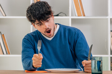 university student in the dining room sitting at the table surprised
