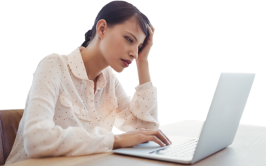 Tired businesswoman using laptop at desk