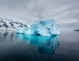 Fototapeta na wymiar Impressive iceberg with blue ice in Antarctica, scenic landscape in Antarctic Peninsula 
