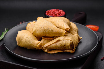 Delicious pancakes triangular shape with meat, salt and spices