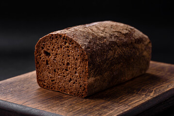 Loaf of fresh crispy brown bread with grains and seeds