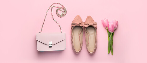 Stylish handbag with female shoes and tulip flowers on pink background