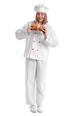 Female baker with fresh bread on white background