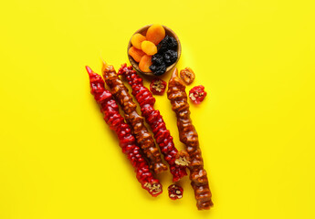 Delicious churchkhela, dried apricot and prunes on yellow background