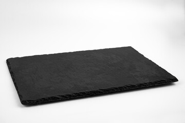 Slate plate isolated on white background. Empty stone tray for food. 