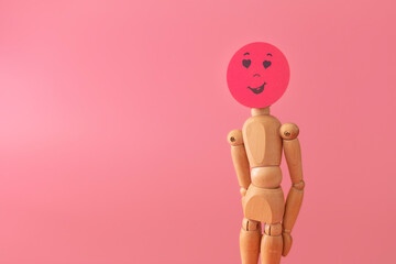 Wood model with love and romance feelings concept, on red background.