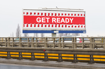 On the highway there is an advertising billboard with the image and the inscription - Get ready