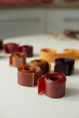 Fruit marshmallows rolled up lies on the table