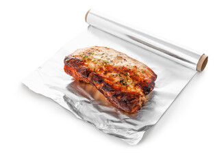 Aluminium foil roll with piece of tasty baked meat on white background