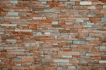 Modern stone brick wall surface background. Brown masonry wall of stones with irregular pattern texture background