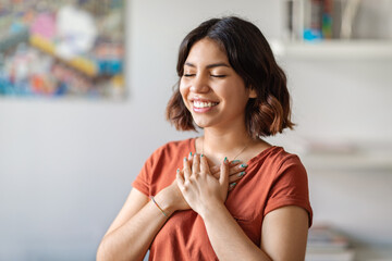 Gratitude Concept. Thankful Arab Woman With Both Palms On Chest Standing Indoors