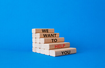 We want to help you symbol. Wooden blocks with words We want to help you. Beautiful blue background. Business and We want to help you concept. Copy space.