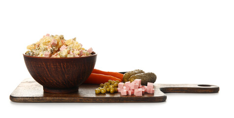 Bowl of tasty Olivier salad and ingredients on white background