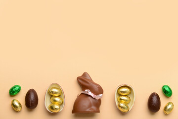 Chocolate bunny and Easter eggs on beige background