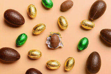 Chocolate Easter eggs on beige background