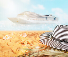 Fototapeta na wymiar Female hat on a golden sand at the tropical beach
