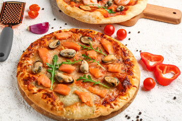 Tasty seafood pizza on light background