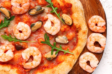 Plate with tasty seafood pizza on light background, closeup