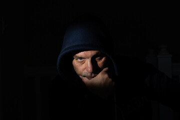 Depressed man with a hood and a scary face