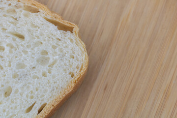 Sliced white bread on wooden board background. Copy space