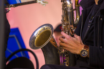 close-up of the hands of a street musician playing the saxophone