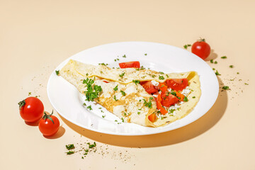 Tasty omelet with tomatoes on beige background