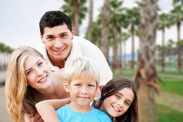 Obraz premium Happy young family having fun in vacation on beach