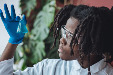 Male african American scientist working in the laboratory making biological test, scientific...