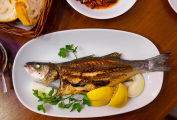 Tasty sea bass with onion, lemon and parsley. Turkish cuisine