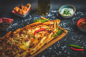 Delicious Turkish minced meat pide, traditional dish, savory flavors, close-up, mouthwatering presentation