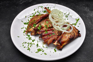 Mouth-Watering Pork Ribs with Onion Rings and Parsley Garnish