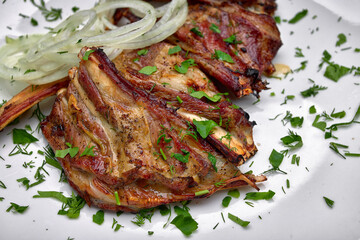 Mouth-Watering Pork Ribs with Onion Rings and Parsley Garnish