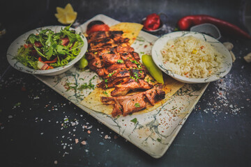 Grilled Lamb Ribs with Sides: Flavorful Meat, Fresh Salad, Turkish Rice, Gourmet Food, Delicious Meal, Tasty Combination, Mediterranean Cuisine, Culinary Delight