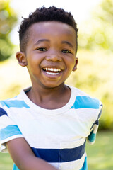 Closeup portrait of cheerful african american cute boy smiling and looking at camera
