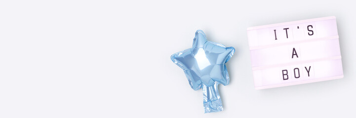 Its a boy - quote. Banner with blue star foil balloon and lightbox. Place for text.