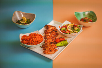 Angled Side View of Grilled Chicken Wings: Flavorful Meat, Golden Crisp, Couscous and Salad Sides, Tasty Combination, Gourmet Food, Culinary Delight, Wholesome Meal