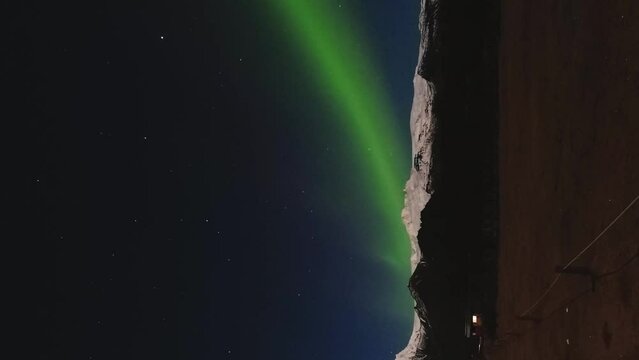 Aurora Borealis over Skaftafell in Iceland with couple on campground enjoy Northern Lights outdoors in nature