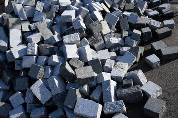 A pile of grey granite cubes