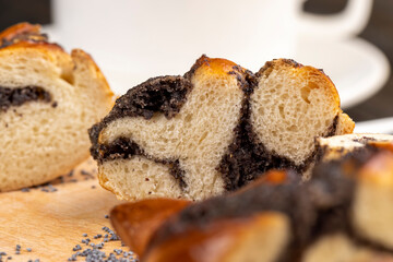 Fresh bun with poppy seed filling on the table