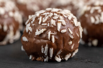 Chocolate candies in the form of balls with milk coconut