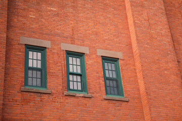 Fototapeta na wymiar Old brick buildings are a symbol of industrial heritage, innovation, and hard work. They represent the industrial revolution and the rise of manufacturing and industry