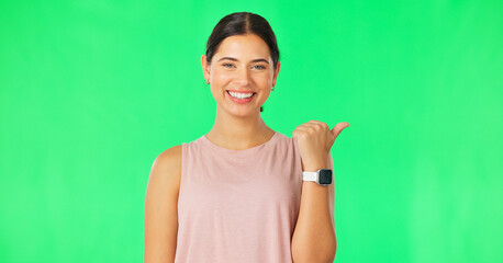 Fototapeta na wymiar Woman face, pointing gesture and green screen with happiness and smile showing advertisement. Portrait, isolated and studio background with a happy young female point to show mock up announcement