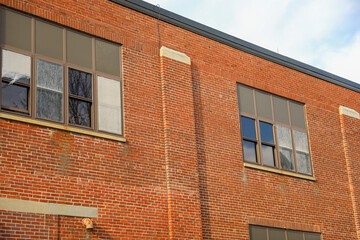 Old brick buildings are a symbol of industrial heritage, innovation, and hard work. They represent the industrial revolution and the rise of manufacturing and industry