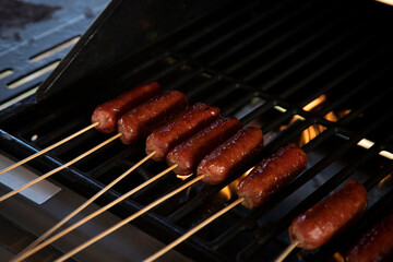 Group of sausages cooking on a grill