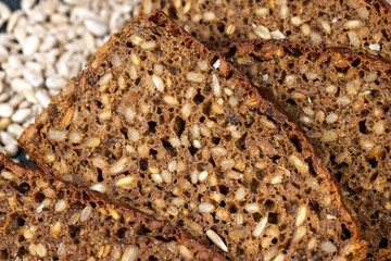 Black rye bread cut into chunks with sunflower seeds