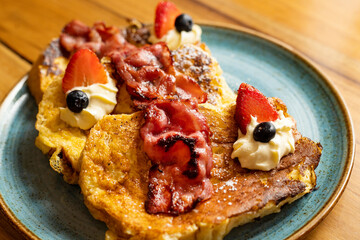 Artisan breakfast of French toast with strawberries, blueberries and maple syrup
